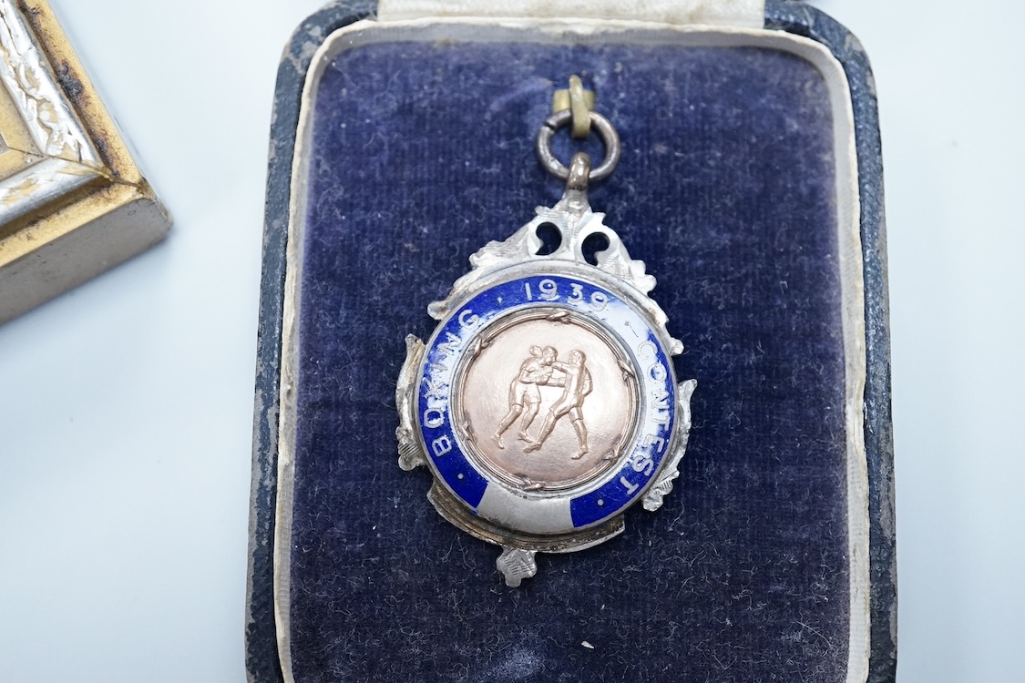 Framed group of eight WWI and WWII medals including a First World War medal pair, the Africa star, the Atlantic star, etc. a hallmarked silver boxing medal and another, both cased, plus a Lancashire and Cheshire Associat